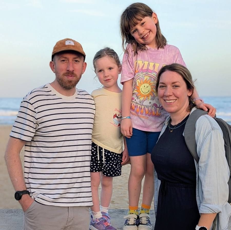 Eddie with Amy and their two daughters on the coast